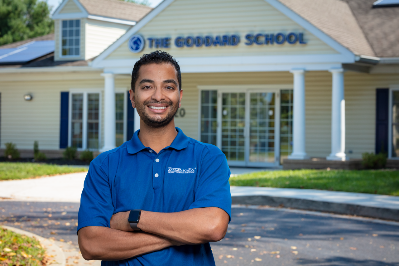 Smiling franchisee standing outside of his Goddard School