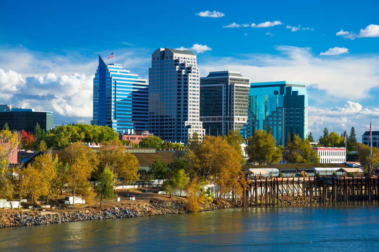 Image of the Sacramento downtown skyline during Autumn with Autumn colored trees in the foreground.